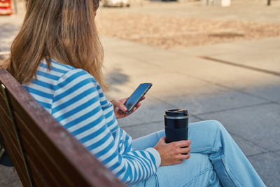 Rear view of woman using mobile phone