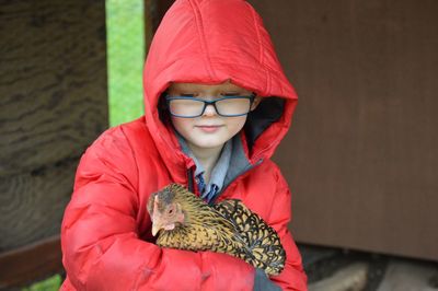 Cute boy holding hen