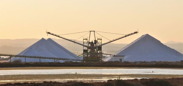 Crane on sand against clear sky