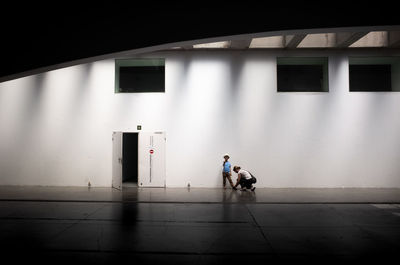 People walking by building