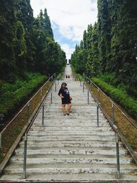 Rear view of woman walking on steps