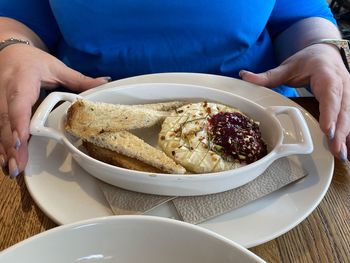 Midsection of man having food in bowl on table