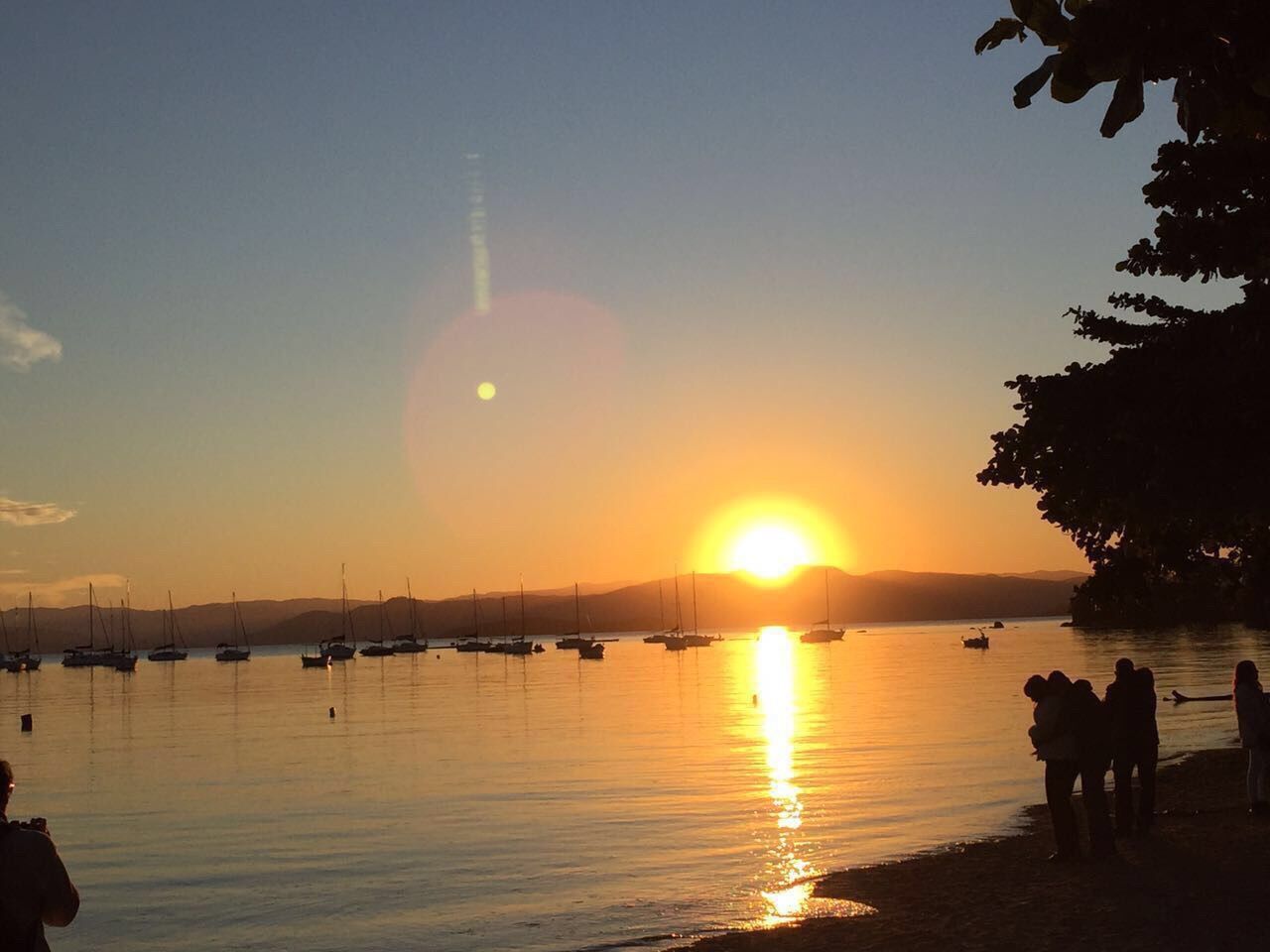 sunset, water, sun, sea, silhouette, reflection, orange color, scenics, beauty in nature, tranquil scene, tranquility, sky, beach, sunlight, idyllic, nature, nautical vessel, horizon over water, sunbeam