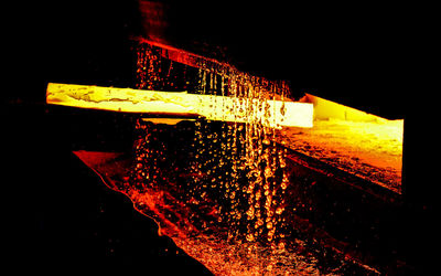 Illuminated ferris wheel against sky at night