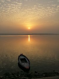 Boat in sea at sunset