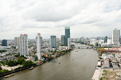 City by river against sky