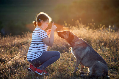 Boy with dog on field