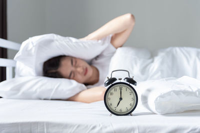 Young woman sleeping on bed at home