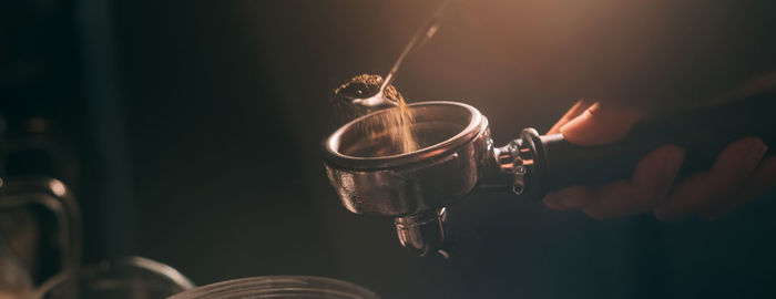 Barista add coffee bean roaster into coffee machine at coffee shop