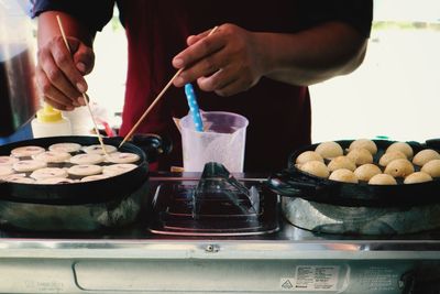 Midsection of man preparing food