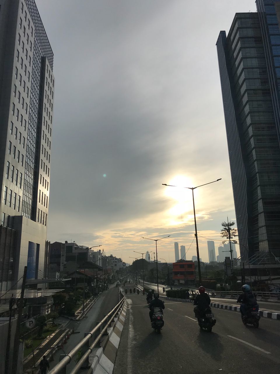 VEHICLES ON ROAD AGAINST SKY