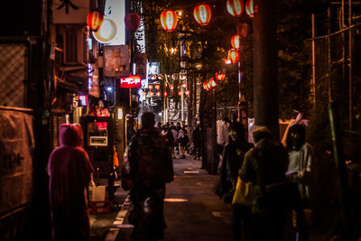 People in illuminated city at night