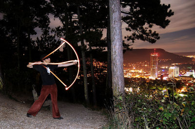 Illuminated christmas tree against sky at night