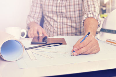 Close-up of man working on table