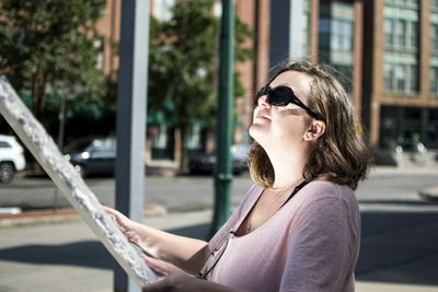 Portrait of man wearing sunglasses in city