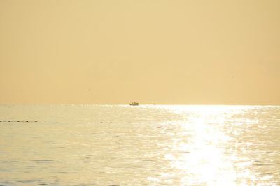 Scenic view of sea against clear sky during sunset