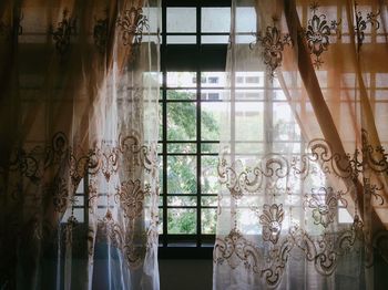 Curtains hanging on window at home