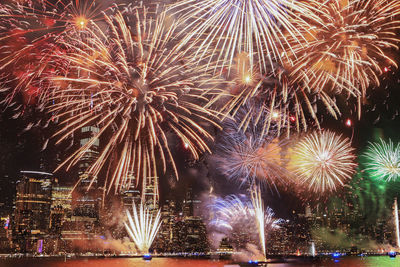 Low angle view of firework display at night