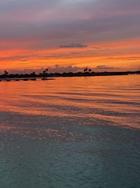 Scenic view of sea against romantic sky at sunset