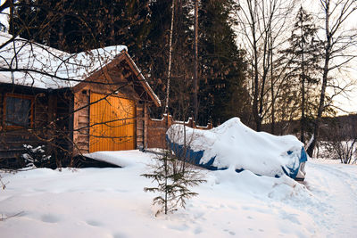 Snow covered field by building