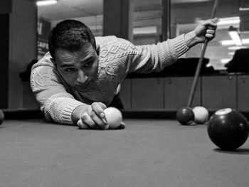 Man playing with ball on table