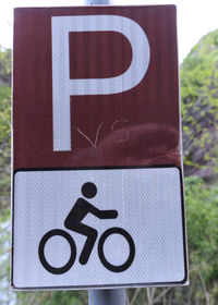 Close-up of arrow sign on road