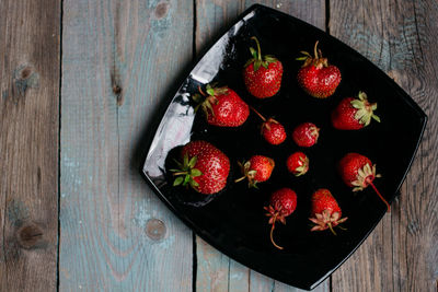 High angle view of strawberries in bowl on table