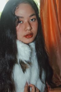 Close-up portrait of a young woman looking away