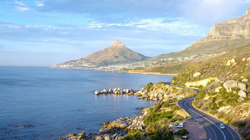 Scenic view of sea and mountains against sky