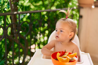 Portrait of shirtless boy looking away