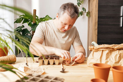 Young man playing chess at home