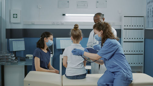 Side view of female doctor working at home