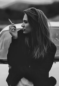 Young woman smoking cigarette