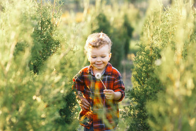 Full length of boy with plants