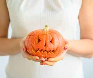 Close-up of woman holding pumpkin