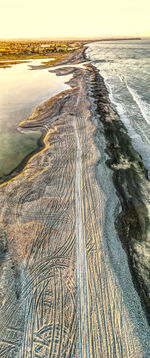 High angle view of beach against sky during sunset