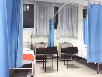 Chairs and beds in hospital ward