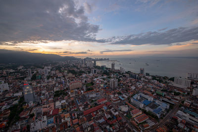 High angle view of modern buildings in city against sky during sunset