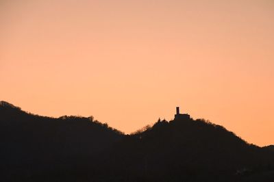 Silhouette mountain against clear sky during sunset