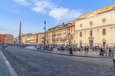 Cobbled street and buildings at piazza navona against sky