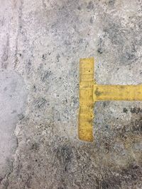 Close-up of yellow arrow sign