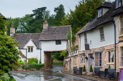 Houses by road against buildings in city