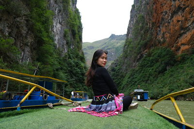 Portrait of young woman standing on mountain