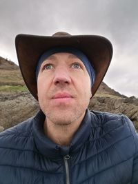 Portrait of man wearing hat, looking out to sea. a moment of reflection, in these uncertain times