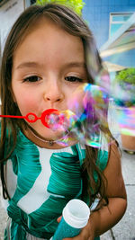 Portrait of cute girl at bubbles