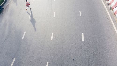 Low section of woman walking on road