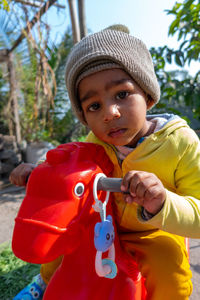 Portrait of cute boy holding camera