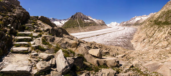 Panoramic view of rocky mountains against clear sky