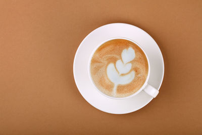 Directly above shot of cappuccino served on table