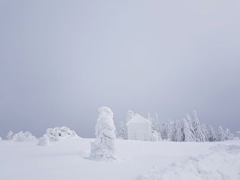 Scenic view of snow covered field against sky